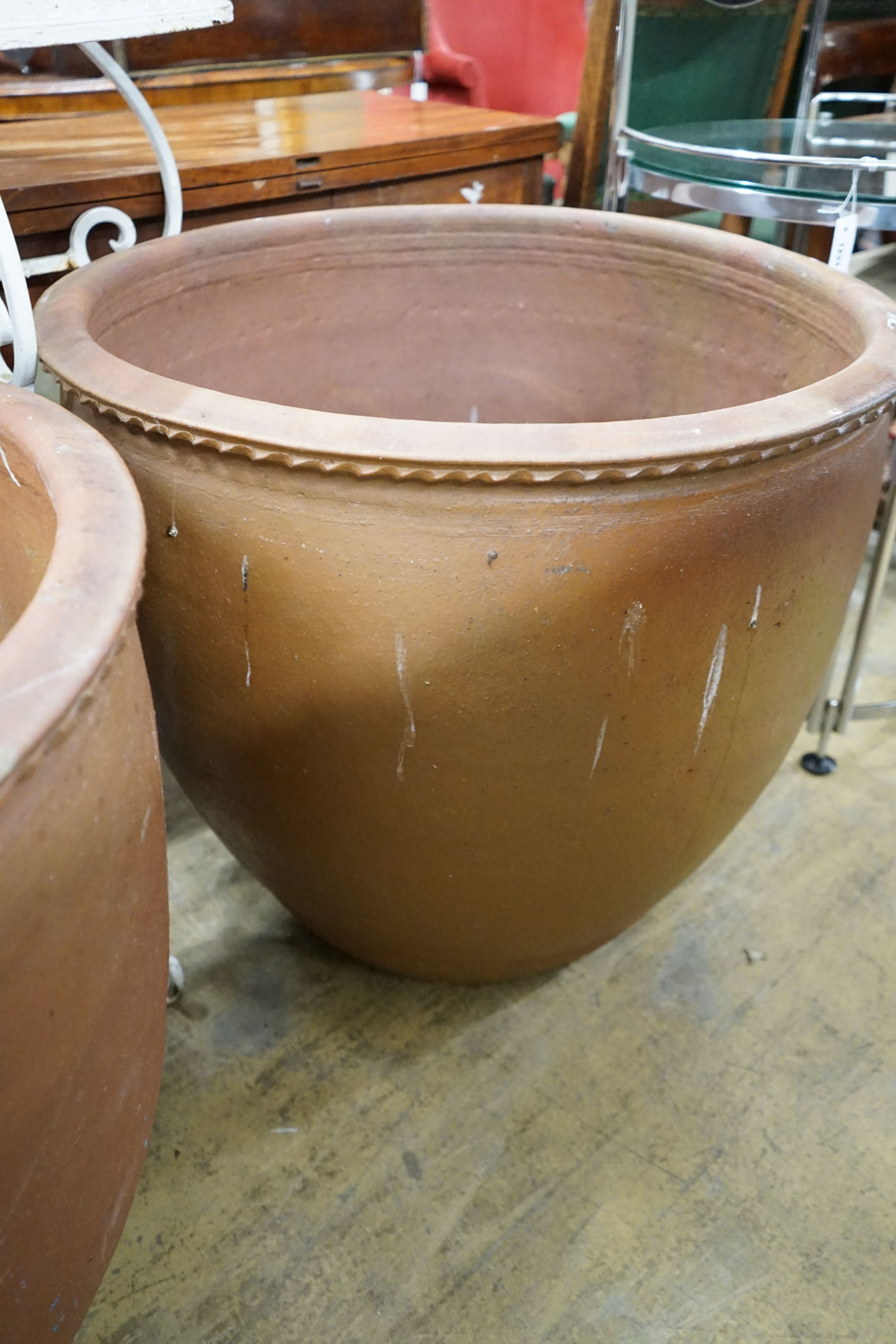 A pair of large circular terracotta planters, diameter 79cm, height 69cm